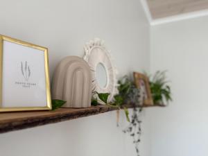 a shelf with a mirror and a picture at Slėnis in Plungė