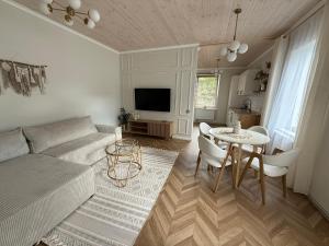a living room with a couch and a table at Slėnis in Plungė