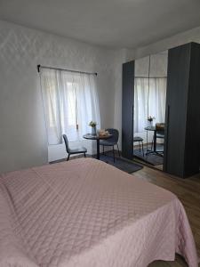 a bedroom with a bed and a table and chairs at Regina Margherita affittacamere in Aulla