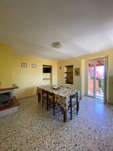 a dining room with a table and a fireplace at Il Casale di Nonna Bambina in Francavilla al Mare