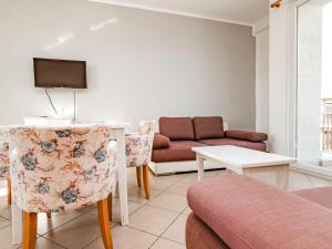 a living room with a couch and a table at Queen Residence & Hotel in Shëngjin