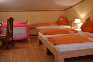 a room with three beds and a chair in it at Romantik-Pension Vogt in Offenburg +60 photos