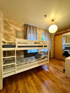 a bedroom with two bunk beds in a room at Manto Apartment in Klaipėda