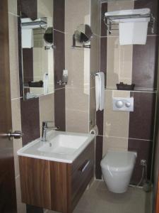 a bathroom with a sink and a toilet at Miroglu Hotel in Diyarbakır