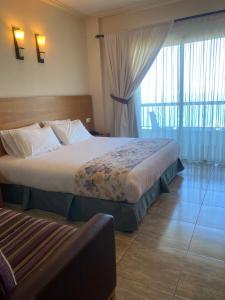 a hotel room with two beds and a window at Victory Byblos Hotel & Spa in Jbeil