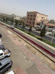 a view of a street with cars parked on the road at ديار الكرم للشقق المفروشه in Baljurashi