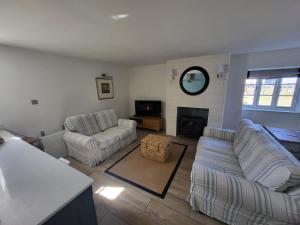 un soggiorno con due divani e un camino di Fishermans Locker a Bridport