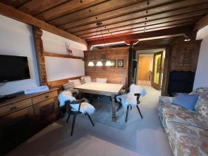a living room with a table and chairs and a couch at Kreidl Top 13 in Königsleiten
