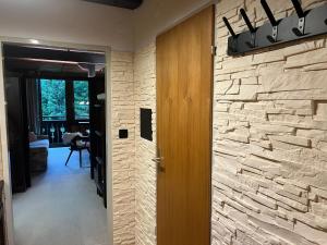 a hallway with a stone wall and a wooden door at Kreidl Top 13 in Königsleiten