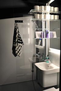 a white bathroom with a sink and a mirror at Lunar Igloos - Ruska - Ellivuori Resort in Karkku