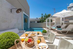 a patio with a table with food on it at Kallisti Palace - Private Pool with Hydromassage in Kissamos