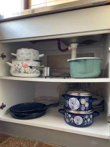 a shelf filled with plates and bowls and pans at Ivaa in Nova Varoš +18 photos
