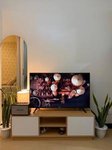 a flat screen tv sitting on a stand in a living room at Welcome to Casa Sheridan Your cozy escape in the heart of the metro Whet in Manila