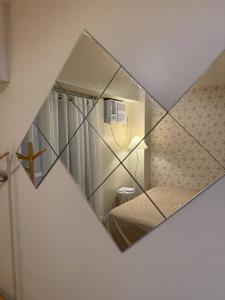 a mirror reflection of a small bedroom with a bed at Welcome to Casa Sheridan Your cozy escape in the heart of the metro Whet in Manila