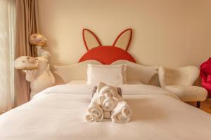 Voodi või voodid majutusasutuse YUSU Hotel 羽宿酒店 toas