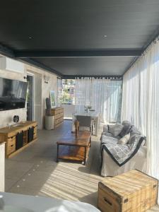 a living room with a couch and a table at PhilHouse, Jacuzzi Seaview & Bbq in Sanremo