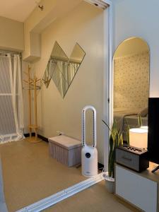 a room with a room with a bed and a mirror at Welcome to Casa Sheridan Your cozy escape in the heart of the metro Whet in Manila +5 photos