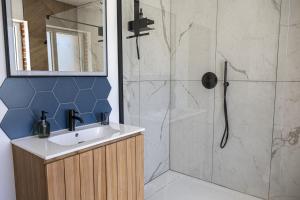 a bathroom with a shower and a sink at Le Cocon - Domaine du Colombier in Vaux-Marquenneville +21 photos