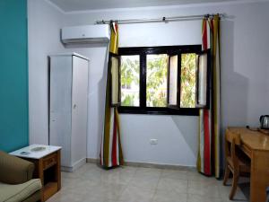 a living room with a window and a table at room 3 a room in Hostel of 4 rooms in Hurghada