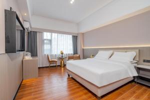Tianmin Holiday Hotel Tianhe Dongpu Olympic Sports Center房間的床