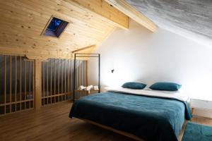 a bedroom with a bed and a wooden ceiling at Villa Wellness in Debar