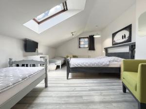 a bedroom with two beds and a skylight at Apartmán Vikárka - dům Karla Hynka Máchy - Litoměřice in Litoměřice