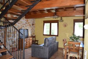 a living room with a staircase and a chair and a table at La Mira in Barriosuso