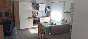 a small kitchen with a table and a couch at FeWo Giehl in Burgebrach