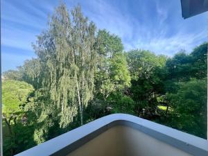 a view of a tree from a balcony at Lauttasaari Studio in Helsinki