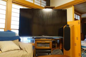 a large flat screen tv in a living room at Natural Mind Tour guest house - Vacation STAY 23273v in Sado
