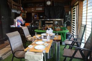 a table with plates on it in a room at Natural Mind Tour guest house - Vacation STAY 23273v in Sado