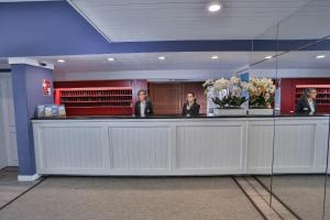 a group of people sitting at a reception counter at Hotel Apartamento Solverde in Espinho