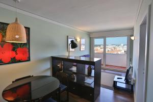 a living room with a desk and a window at Hotel Apartamento Solverde in Espinho