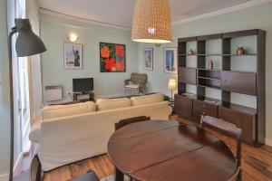 a living room with a couch and a table at Hotel Apartamento Solverde in Espinho