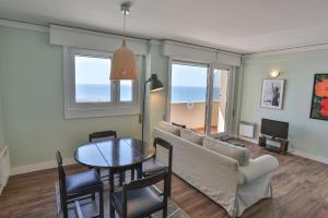 a living room with a couch and a table at Hotel Apartamento Solverde in Espinho