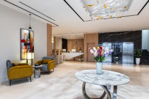 a lobby with a table with flowers on it at Al Qasr Hotel Taif in Taif