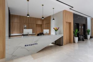 an office with a reception desk in a lobby at Al Qasr Hotel Taif in Taif