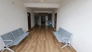 an empty room with two chairs and a wooden floor at Sri Annapurna Residency in Drākshārāma
