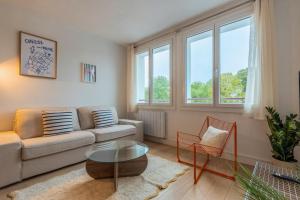 a living room with a couch and a table at Two bedroom apartment near shops & tram in Villeneuve d'Ascq
