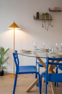 a dining room with a blue table and chairs at Two bedroom apartment near shops & tram in Villeneuve d'Ascq