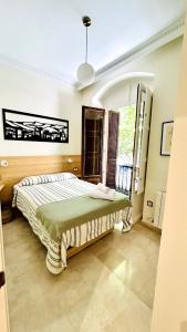 a bedroom with a bed and a large window at Luxury Suite La Tribuna del Paseo in Granada