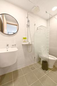 a bathroom with a tub and a sink and a mirror at Seoul DDJ STAY 대동장 in Seoul