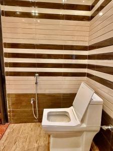 a bathroom with a white toilet in a room at Renu's Hillside Homestay in Kamakhya +12 photos