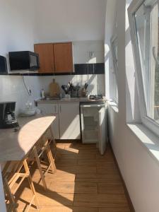 a small kitchen with a table and a counter top at Căsuța cu Izvor in Călimăneşti