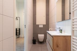 a small bathroom with a toilet and a sink at Utrecht City Apartments - Maliesingel in Utrecht +34 photos
