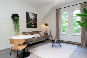 a living room with a couch and a table at Utrecht City Apartments - Maliesingel in Utrecht