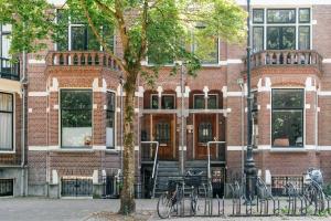 a brick building with bikes parked in front of it at Utrecht City Apartments - Maliesingel in Utrecht
