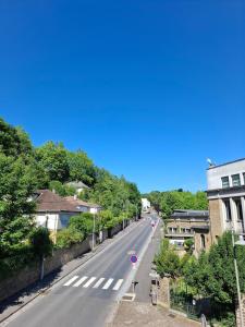 an empty street in a town with a blue sky at Le repos de Turenne in Sedan