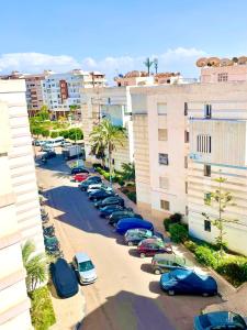 a row of cars parked in a parking lot at Chic Design Stay With a Chocolate Welcome Gift in Agadir