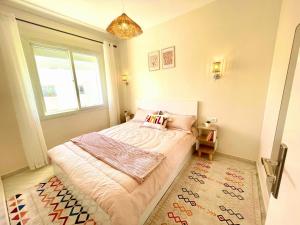 a small bedroom with a bed and a window at Chic Design Stay With a Chocolate Welcome Gift in Agadir